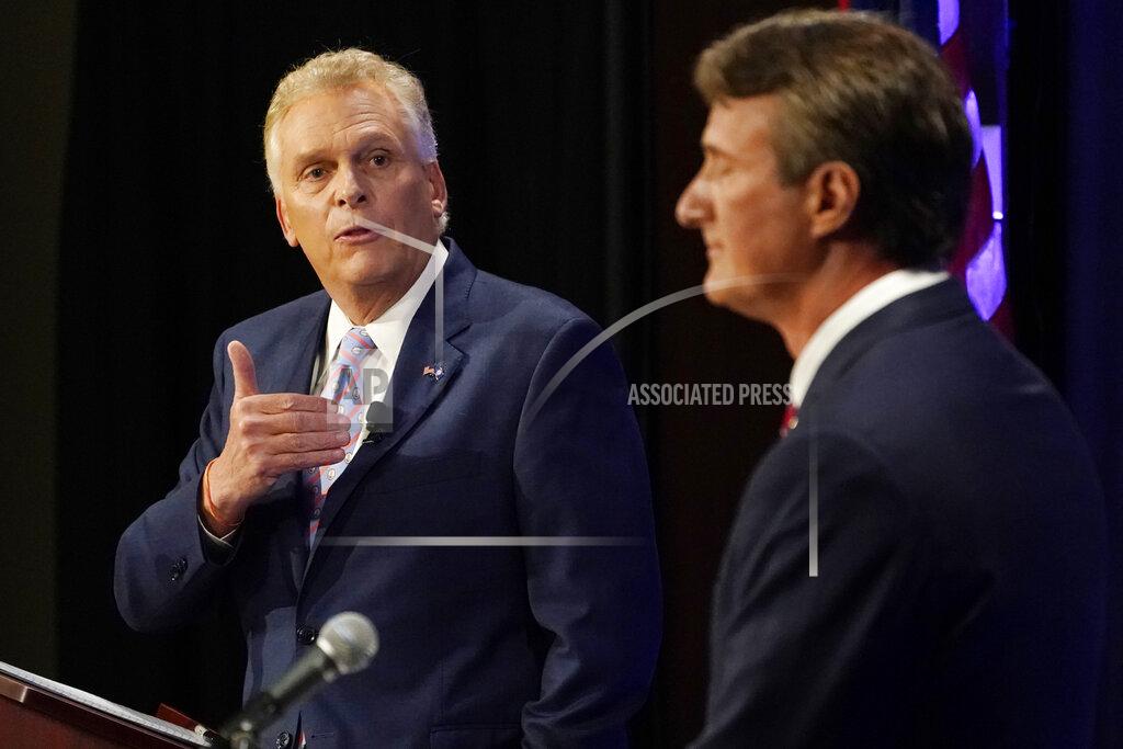 Steve Helber Democratic gubernatorial candidate former Governor Terry McAuliffe, left, gestures as Republican challenger, Glenn Youngkin, listens during a debate at the Appalachian School of Law in Grundy, Va., Thursday, Sept. 16, 2021. (AP Photo/Steve Helber)