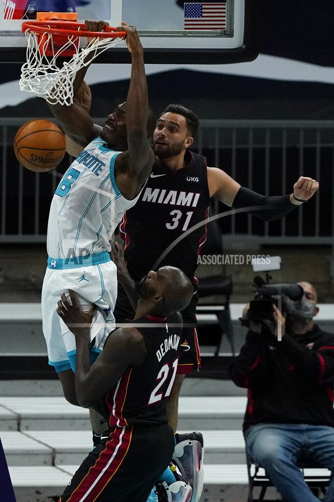 Chris Carlson Charlotte Hornets center Bismack Biyombo dunks past Miami Heat guard Max Strus (31) and center Dewayne Dedmon during the first half of an NBA basketball game on Sunday, May 2, 2021, in Charlotte, N.C. (AP Photo/Chris Carlson)