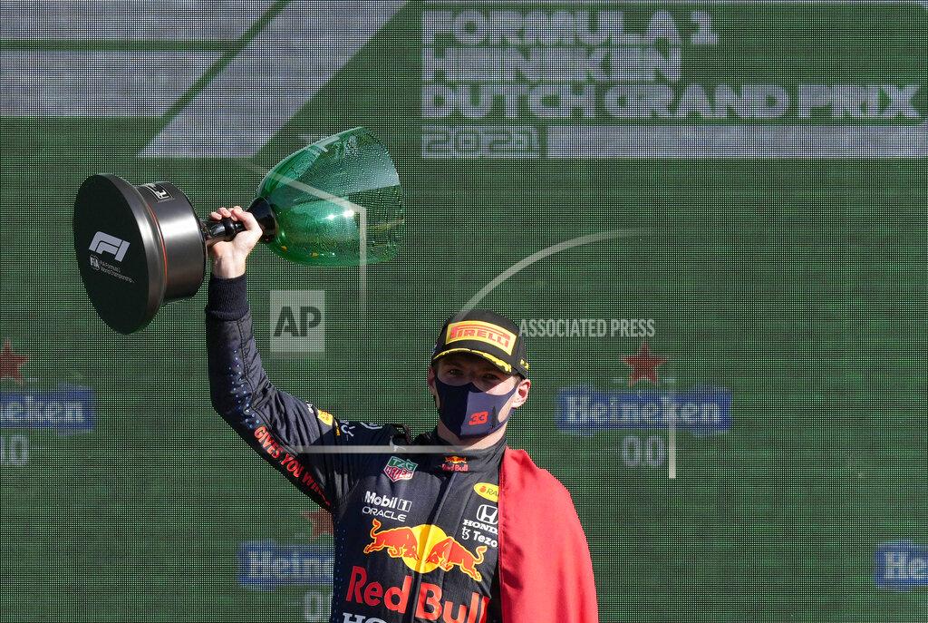 Peter Dejong Red Bull driver Max Verstappen of the Netherlands celebrates on the podium after winning the Formula One Dutch Grand Prix, at the Zandvoort racetrack, Netherlands, Sunday, Sept. 5, 2021. (AP Photo/Peter Dejong)
