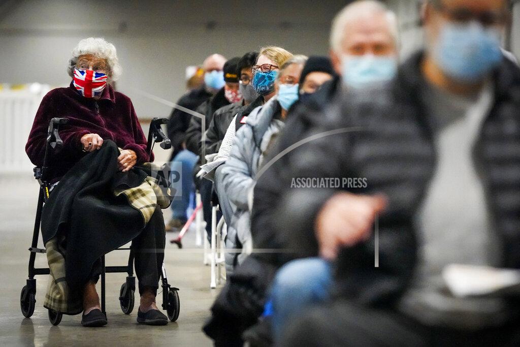 Smiley N. Pool Georgette McGarrad, 99, (left) waits to receive the COVID-19 vaccine at Fair Park on Monday, Jan. 11, 2021, in Dallas. Dallas County launched its first "mega" public COVID-19 vaccination site Monday at Fair Park. (Smiley N. Pool/The Dallas Morning News via AP)