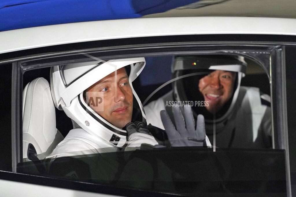 John Raoux European Space Agency astronaut Thomas Pesquet, of France, left, and Japan Aerospace Exploration Agency astronaut Akihiko Hoshide wave as they leave the operations and checkout building before a launch attempt Friday, April 23, 2021, at the Kennedy Space Center in Cape Canaveral, Fla. Four astronauts will fly on the SpaceX Crew mission to the International Space Station scheduled for launch on April 23, 2021. (AP Photo/John Raoux)