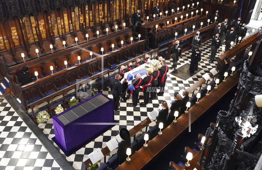 Dominic Lipinski Britain's Queen Elizabeth watches as pallbearers carry the coffin of the Duke of Edinburgh during his funeral at St George's Chapel in Windsor Castle, Windsor, England, Saturday April 17, 2021. Prince Philip died April 9 at the age of 99 after 73 years of marriage to Britain's Queen Elizabeth II. (Dominic Lipinski/Pool via AP)