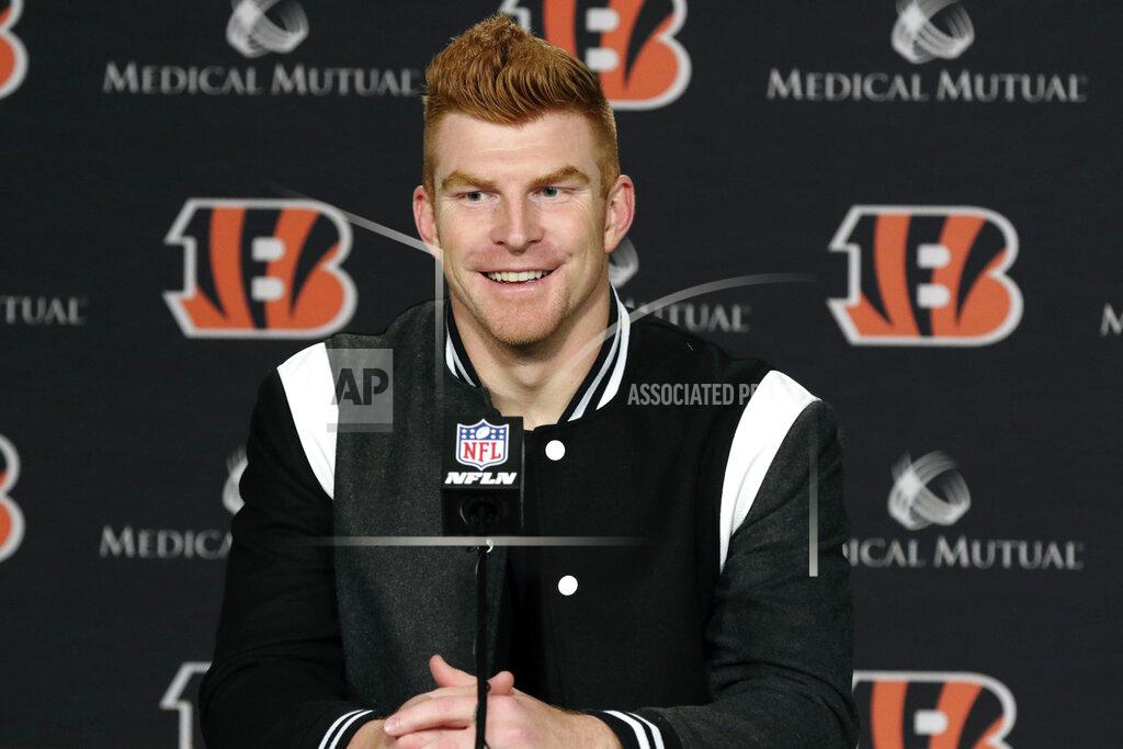 FILE - In this Dec. 29, 2019, file photo, Cincinnati Bengals quarterback Andy Dalton answers questions after his team defeated the Cleveland Browns in an NFL football game in Cincinnati. Dalton is coming home to Texas as Dak Prescott's backup with the Dallas Cowboys. Dalton and the Cowboys agreed to a one-year deal that guarantees the former Cincinnati starter $3 million and could be worth up to $7 million, two people with direct knowledge of the deal told The Associated Press on Saturday, May 2, 2020. (AP Photo/Gary Landers, File)