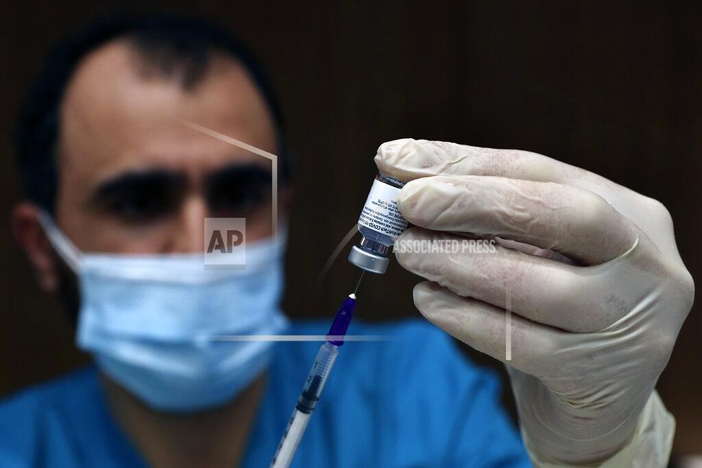Bilal Hussein A medic prepares a syringe of the Pfizer-BioNTech COVID-19 vaccine during a nationwide vaccination campaign, at the American University Medical Center in Beirut, Lebanon, Sunday, Feb. 14, 2021. (AP Photo/Bilal Hussein)