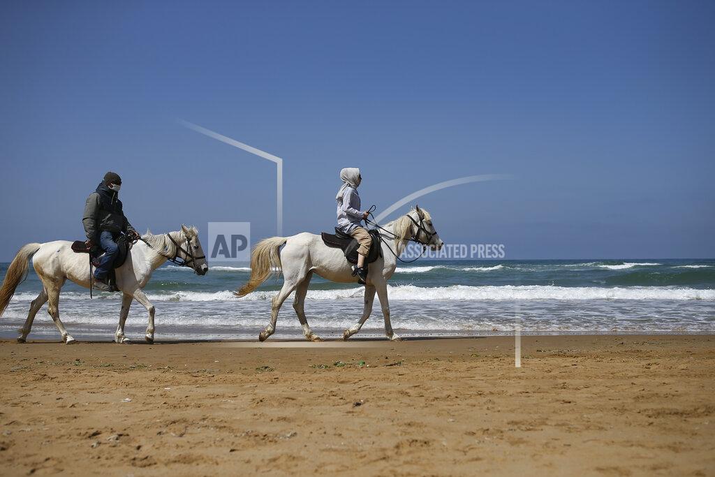 Emrah Gurel People ride horses on the beach in Kilyos, northern Istanbul, Thursday, April 29, 2021, a few hours before the start of the latest lockdown to help protect from the spread of the coronavirus. People stocked up on groceries, shoppers filled markets and many left cities for their hometowns or the southern coast as Turkey's strictest COVID-19 lockdown yet came into effect late Thursday. President Recep Tayyip Erdogan imposed a "full lockdown" until May 17 amid soaring COVID-19 infections and deaths. Turkey now ranks among the world's worst-hit countries and it's the first time that it is imposing a nearly three-week lockdown for the whole of the country. (AP Photo/Emrah Gurel)