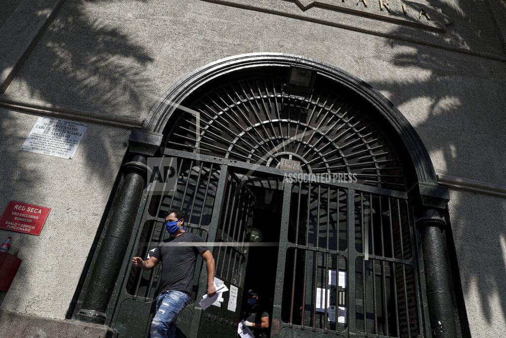 Esteban Felix A low-risk inmate leaves the National Penitentiary released under a commutative general pardon as a measure to prevent overcrowding in prisons in an effort to curb the spread of the new coronavirus in Santiago, Chile, Saturday, April 18, 2020. (AP Photo/Esteban Felix)