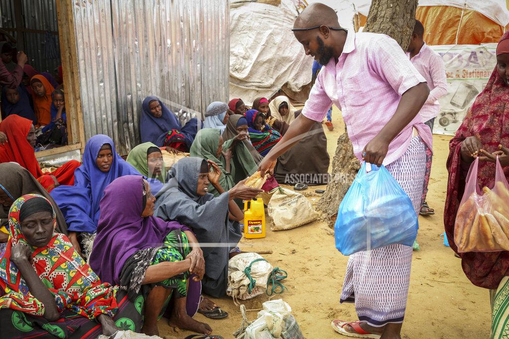Farah Abdi Warsameh Somalis who fled drought-stricken areas receive charitable food donations from city residents after arriving at a makeshift camp for the displaced on the outskirts of Mogadishu, Somalia Thursday, June 30, 2022. The war in Ukraine has abruptly drawn millions of dollars away from longer-running humanitarian crises and Somalia is perhaps the most vulnerable as thousands die of hunger amid the driest drought in decades. (AP Photo/Farah Abdi Warsameh)