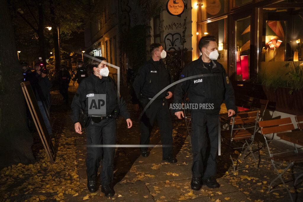 Paul Zinken A patrol of the federal police goes along Kollwitz-Platz in Berlin, Germany, Saturday, Oct.24, 2020. In connection with the corona restrictions, numerous police officers checked during the night that the curfew and contact restrictions were being observed. (Paul Zinken/dpa via AP)