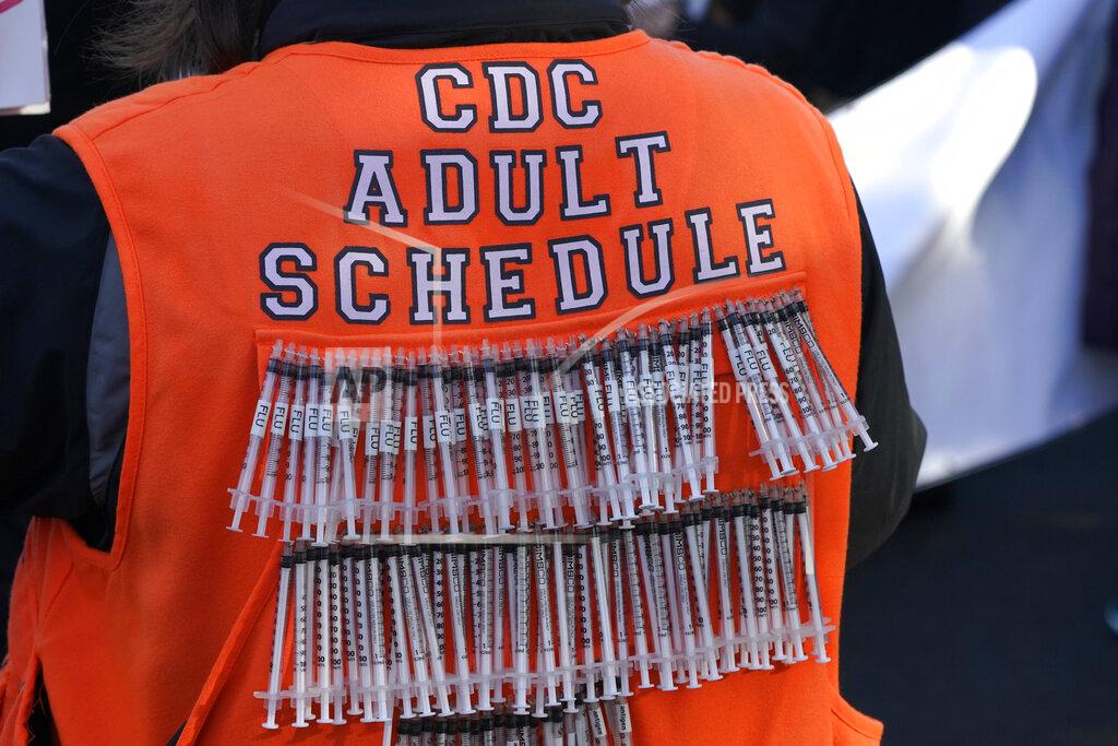 A person opposed to vaccines wears syringes on their vest during a rally, Sunday, Jan. 10, 2021, at the Capitol in Olympia, Wash. Protesters from several causes rallied Sunday at the Capitol, the day before the 2021 legislative session was scheduled to begin. (AP Photo/Ted S. Warren)