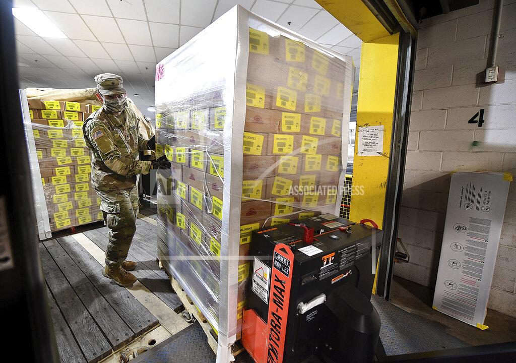 Members of the 128th Brigade Support Battalion of the Pennsylvania Army National Guard work loading boxes of food at a distribution for the Greater Pittsburgh Community Food Bank, Monday, April 20, 2020, in Duquesne, Pa. The food bank has seen a sharp increase in need since statewide shutdowns of non-essential businesses in the COVID-19 pandemic. (Darrell Sapp/Pittsburgh Post-Gazette via AP)