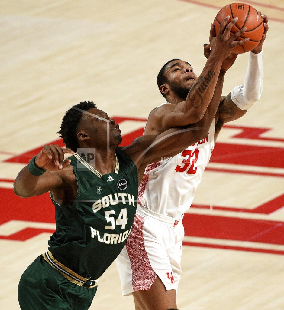 Eric Christian Smith Houston forward Reggie Chaney (32) and South Florida center Russel Tchewa (54) vie for a rebound during the second half of an NCAA college basketball game, Sunday, Feb. 28, 2021, in Houston. (AP Photo/Eric Christian Smith)
