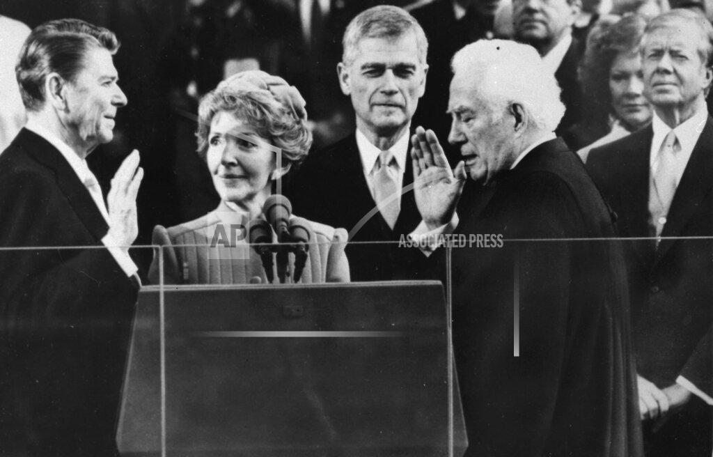 Bob Daugherty FILE - In this Jan. 20, 1981, file photo Supreme Court Chief Justice Warren Burger administers the oath of office to Ronald Reagan, as Nancy Reagan holds the bible, at the Capitol in Washington. Outgoing President Jimmy Carter and wife Rosalynn look on at right. (AP Photo/Bob Daugherty, File)