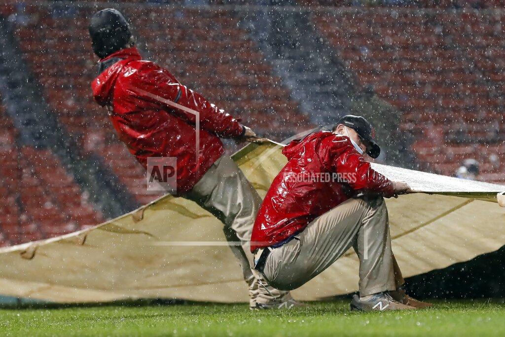 Michael Dwyer The Fenway Park grounds crew pulls out the tarp during a rain delay during a baseball game between the Boston Red Sox and the Miami Marlins during the sixth inning Friday, May 28, 2021, in Boston. (AP Photo/Michael Dwyer)