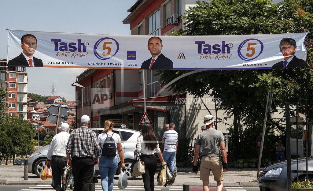 Boris Grdanoski An electoral campaign banner of the opposition ethnic Albanian coalition Alliance for the Albanians and Alternative, is displayed above a pedestrian crossing in Skopje, North Macedonia on Saturday, July 11, 2020. North Macedonia holds its first parliamentary election under its new country name this week, with voters heading to the polls during an alarming spike of coronavirus cases in the small Balkan nation. (AP Photo/Boris Grdanoski)