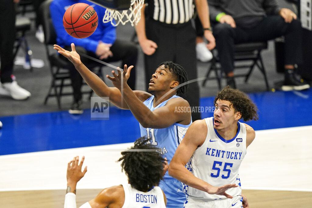 Tony Dejak North Carolina's Day'Ron Sharpe (11) tries to get a rebound ahead of Kentucky's Lance Ware (55) and Brandon Boston Jr. (3) in the first half of an NCAA college basketball game, Saturday, Dec. 19, 2020, in Cleveland. (AP Photo/Tony Dejak)
