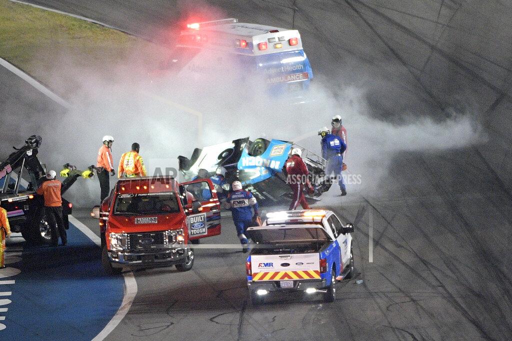 Phelan M. Ebenhack Track personnel arrive to help Ryan Newman (6) after he flipped his car on the final lap in front of the grandstands during the NASCAR Daytona 500 auto race at Daytona International Speedway, Monday, Feb. 17, 2020, in Daytona Beach, Fla. (AP Photo/Phelan M. Ebenhack)