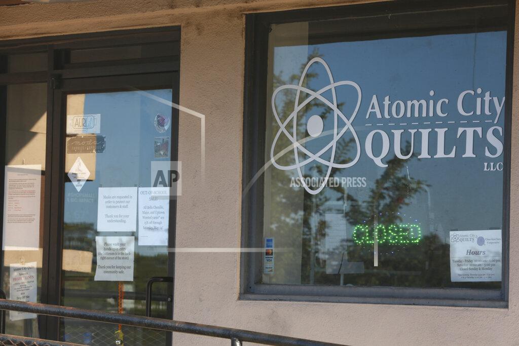 Morgan Lee A storefront window announces a work hiatus on Thursday, May 12, 2022, as residents of Los Alamos, N.M., prepared to possibly flee a wildfire as it crept within a few miles of the city and companion national security laboratory. Scientists at Los Alamos National Laboratory are using supercomputers and ingenuity to improve wildfire forecasting and forest management amid drought and climate change in the American West. (AP Photo/Morgan Lee)