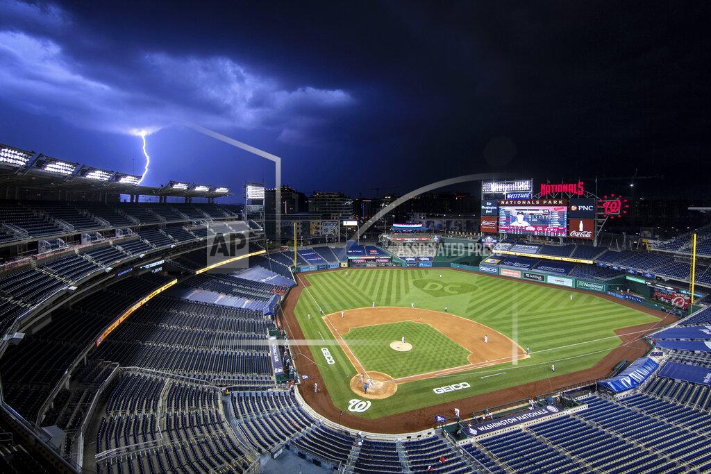 Alex Brandon A bolt of lightning comes down from the clouds during the sixth inning of an opening day baseball game between the Washington Nationals and the New York Yankees at Nationals Park, Thursday, July 23, 2020, in Washington. (AP Photo/Alex Brandon)