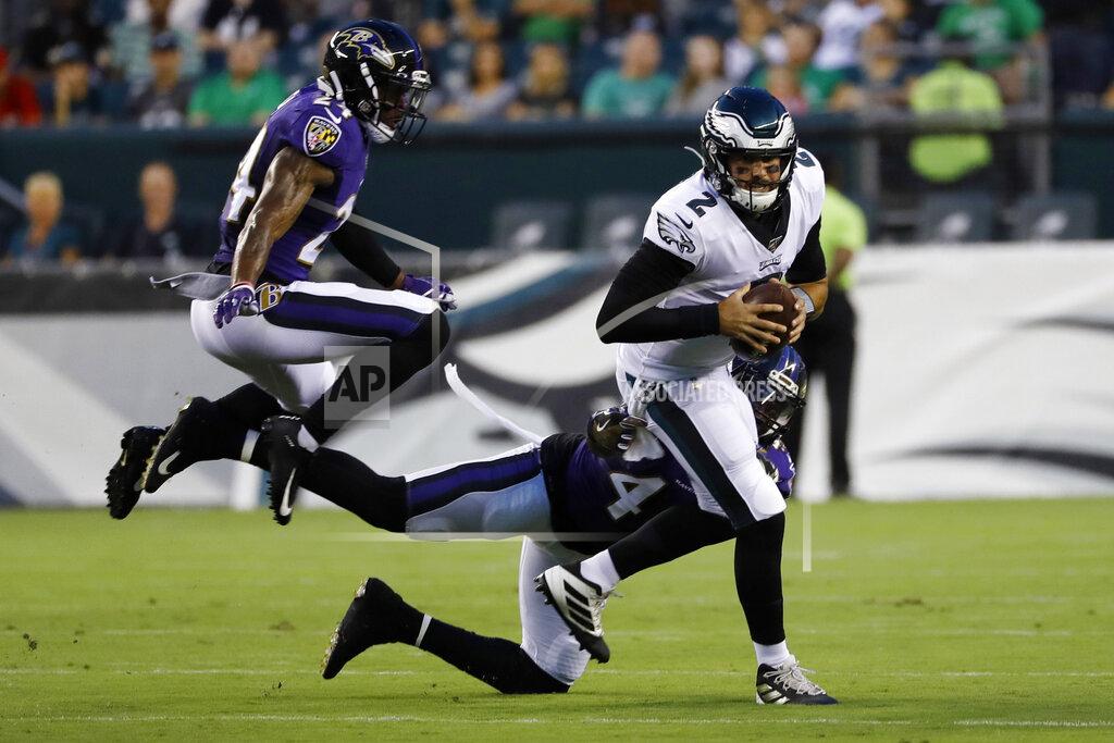 Michael Perez Philadelphia Eagles' Cody Kessler (2) is tackled by Baltimore Ravens' Patrick Onwuasor (48) and Brandon Carr (24) during the first half of a preseason NFL football game Thursday, Aug. 22, 2019, in Philadelphia. (AP Photo/Michael Perez)