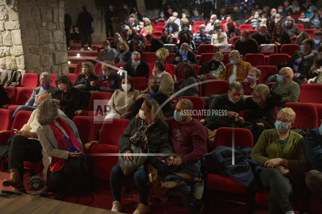 Maya Alleruzzo The audience waits on opening night at the Khan Theater during a performance where all guests were required to show proof of receiving a COVID-19 vaccination or full recovery from the virus, in Jerusalem, Tuesday, Feb. 23, 2021. (AP Photo/Maya Alleruzzo)
