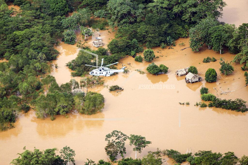 Lphot Robert Oates In this undated handout photo provided by the Ministry of Defence on Saturday, Nov. 21, 2020, a Merlin Helicopter from 845 Naval Air Squadron conducting damage surveys in Honduras. The devastation caused by Hurricane Iota is becoming clear as communications are restored after the second Category 4 hurricane in two weeks to blast Nicaragua’s Caribbean coast. The official death toll rose in Nicaragua with victims swept away by swollen rivers or buried in landslides. (LPhot Robert Oates/Ministry of Defence via AP)