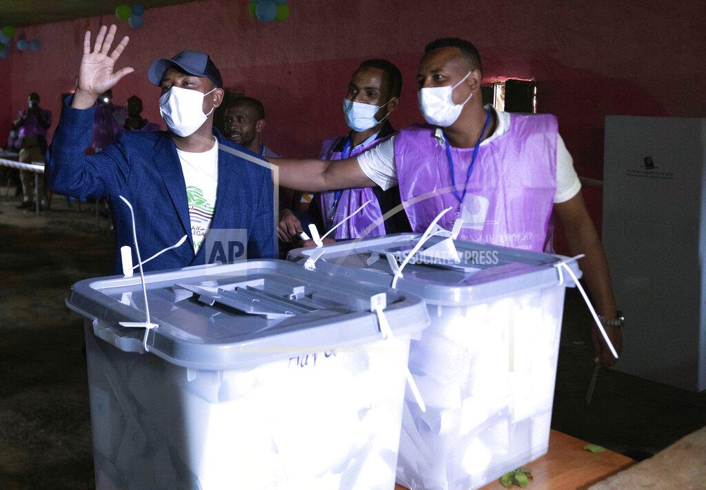 Mulugeta Ayene Ethiopia's Prime Minister Abiy Ahmed, left, waves to his supporters after casting his vote in the general election in his home town of Beshasha, in the Oromia region of Ethiopia Monday, June 21, 2021. Ethiopia began voting in the greatest electoral test yet for Prime Minister Abiy Ahmed as war and logistical issues mean ballots won’t be cast in more than 100 of the 547 constituenciesacross the country. The election is the centerpiece of a reform drive by Abiy, whose rise to power in 2018 seemed to signal a break with decades of authoritarian rule and led to him winning a Nobel Peace Prize. (AP Photo/Mulugeta Ayene)
