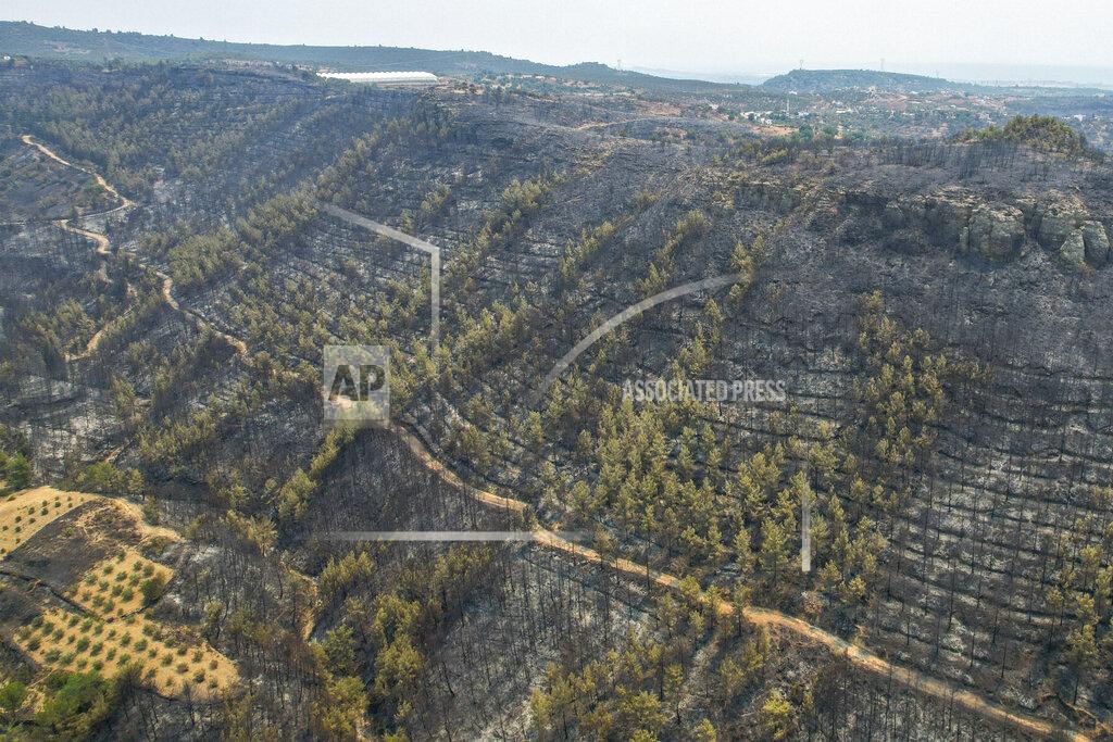 Uncredited An aerial photo shows the destruction by wildfires near the Mediterranean coastal town of Manavgat, Antalya, Turkey, Friday, July 30, 2021. The death toll in a string of wildfires raging in southern Turkey rose to four, officials said Friday, as fire crews continued to battle blazes that burned down homes and forced people to evacuate settlements and beach resorts. Firefighters were still tackling wildfires in 14 locations in six provinces in Turkey's Mediterranean and southern Aegean region, President Recep Tayyip Erdogan told reporters. (AP Photo)
