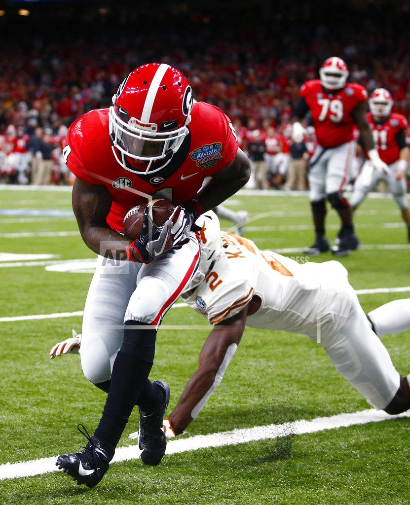 Butch Dill Georgia wide receiver Mecole Hardman (4) scores a touchdown against Texas defensive back Kris Boyd (2) during the second half of the Sugar Bowl NCAA college football game in New Orleans, Tuesday, Jan. 1, 2019. (AP Photo/Butch Dill)