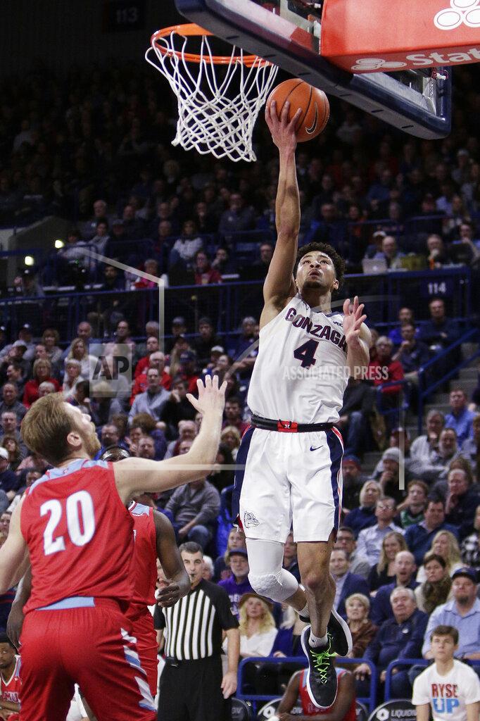 Young Kwak Gonzaga guard Ryan Woolridge (4) shoots in front of Loyola Marymount guard Erik Johansson (20) during the first half of an NCAA college basketball game in Spokane, Wash., Thursday, Feb. 6, 2020. (AP Photo/Young Kwak)