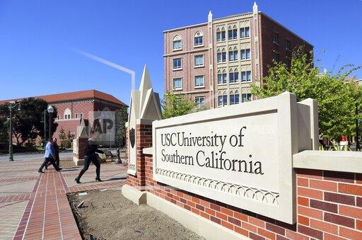 FILE - This March 12, 2019, file photo shows the University Village area of the University of Southern California, in Los Angeles. A former assistant women's soccer coach at the University of Southern California testified Monday, Sept. 27, 2021 during the first trial in the nationwide college admissions bribery scandal that she regularly created fake athletic profiles with exaggerated accomplishments to help get unqualified students admitted to the school. (AP Photo/Reed Saxon, File)