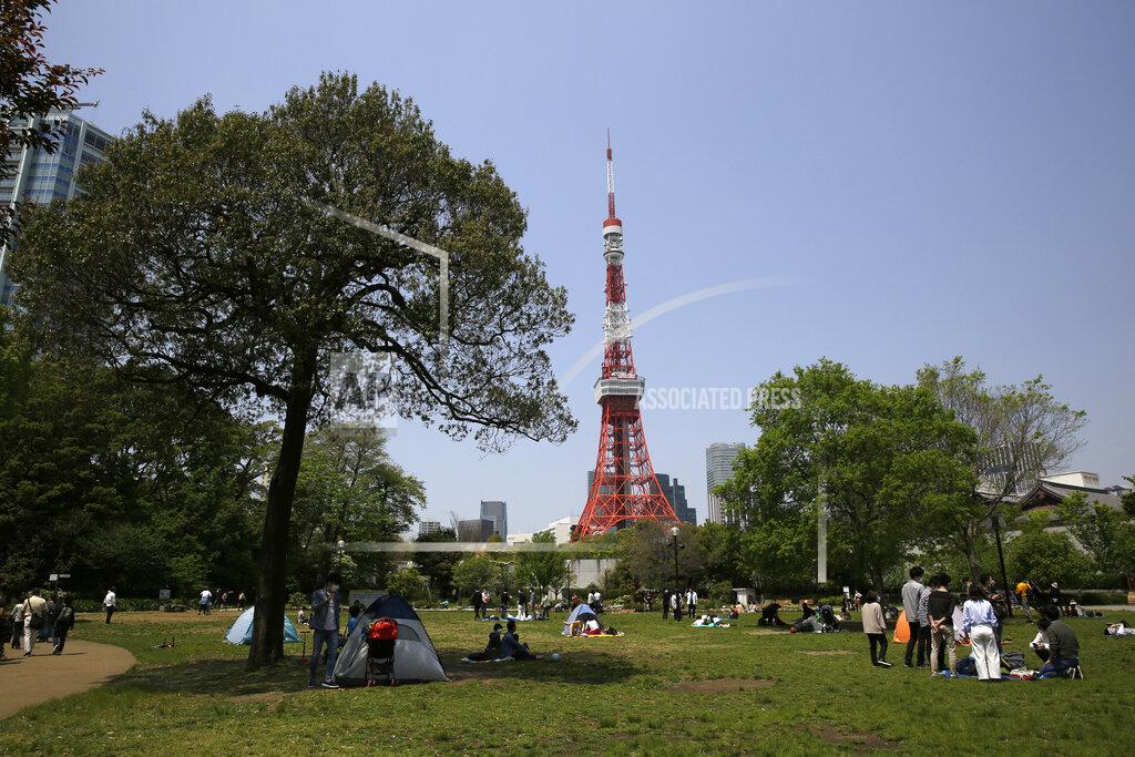 Kiichiro Sato In this April 29, 2020 photo, Shiba Park is packed with families with small children day camping in tents on the first day of the "Golden Week" holidays in Tokyo. Under Japan's coronavirus state of emergency, people have been asked to stay home. Many are not. Some still have to commute to their jobs despite risks of infection, while others are dining out, picnicking in parks and crowding into grocery stores with scant regard for social distancing. (AP Photo/Kiichiro Sato)