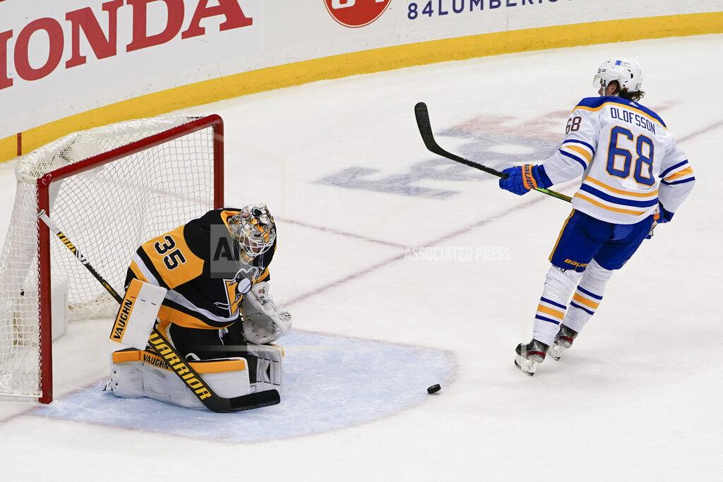 Keith Srakocic The puck bounces out of the net after Buffalo Sabres' Victor Olofsson (68) scored on a penalty shot on Pittsburgh Penguins goaltender Tristan Jarry (35) during the third period of an NHL hockey game, Wednesday, March 24, 2021, in Pittsburgh. Olofsson was awarded a penalty shot on the play and scored on that. The Penguins won 5-2. (AP Photo/Keith Srakocic)