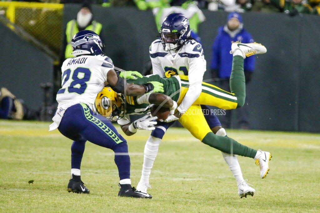 Mike Roemer Green Bay Packers' Geronimo Allison is stopped by Seattle Seahawks' Ugo Amadi (28) and Tre Flowers (21) during the first half of an NFL divisional playoff football game Sunday, Jan. 12, 2020, in Green Bay, Wis. (AP Photo/Mike Roemer)