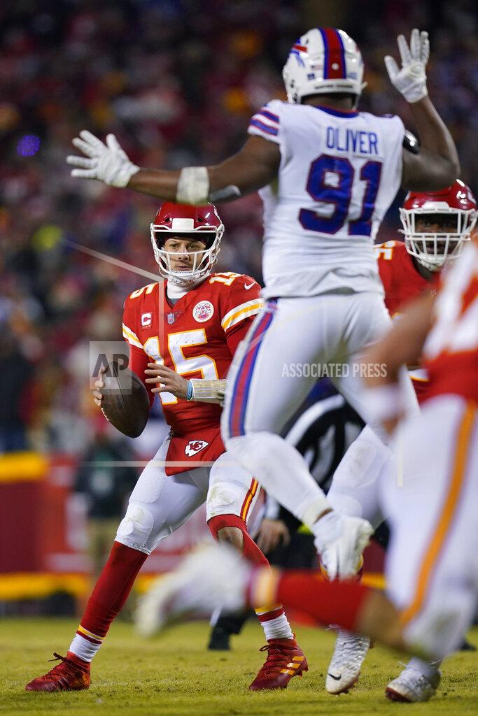 Ed Zurga Kansas City Chiefs quarterback Patrick Mahomes (15) looks to pass around Buffalo Bills defensive tackle Ed Oliver (91) during the second half of an NFL divisional round playoff football game, Sunday, Jan. 23, 2022, in Kansas City, Mo. (AP Photo/Ed Zurga)