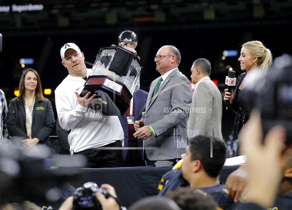 Gerald Herbert Appalachian State interim head coach Mark Ivey holds up the bowl trophy after defeating Middle Tennessee in the New Orleans Bowl NCAA college football game in New Orleans, Saturday, Dec. 15, 2018. Appalachian State won 45-13.(AP Photo/Gerald Herbert)