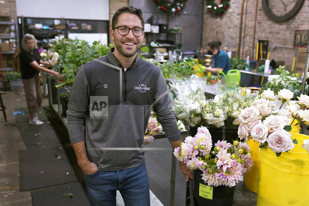 Charles Rex Arbogast Steven Dyme, owner of Flowers for Dreams, poses for a portrait at his warehouse Friday, July 23, 2021, in Chicago. Dyme says the $15 minimum made it much easier to staff up when the economy reopened this spring and demand for flowers, particularly for weddings, soared. The company has four locations, including its headquarters in Chicago, one in Milwaukee, and two in Detroit. (AP Photo/Charles Rex Arbogast)