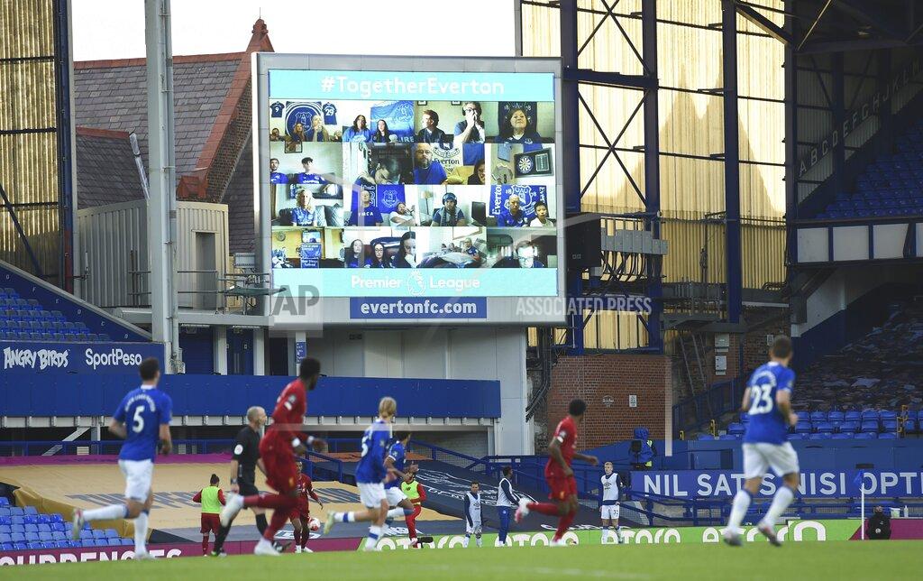 Peter Powell Everton fans are displayed on a large screen as the watch remotely the English Premier League soccer match between Everton and Liverpool at Goodison Park in Liverpool, England, Sunday, June 21, 2020. (Peter Powell/Pool via AP)