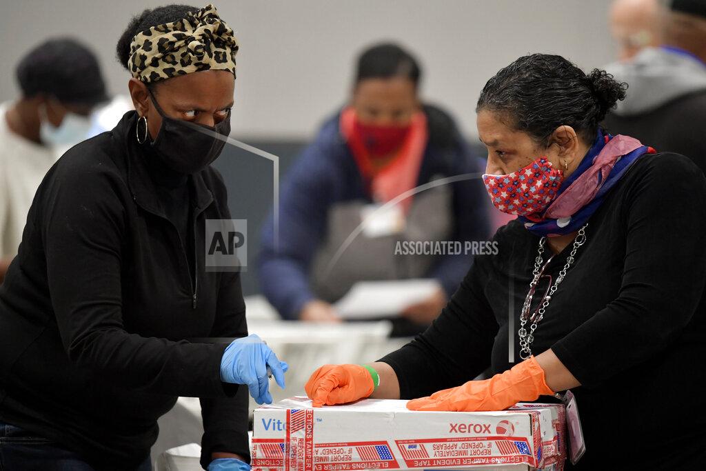 Mike Stewart Cobb County Election officials unseal a box of election ballots during an audit, Friday, Nov. 13, 2020, in Marietta, Ga. (AP Photo/Mike Stewart)