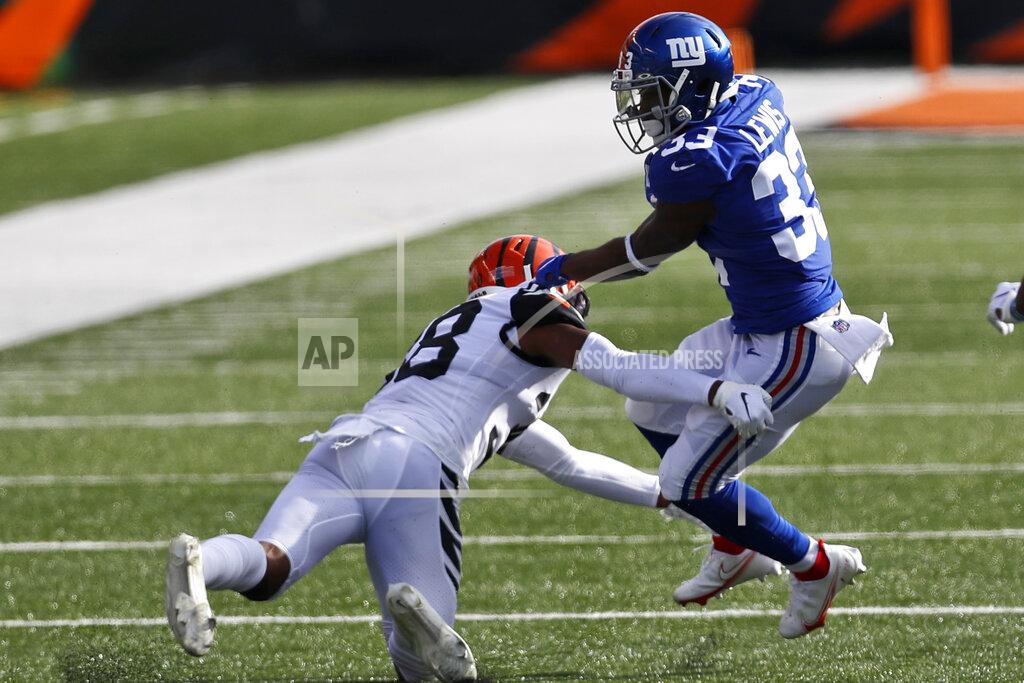 Aaron Doster Cincinnati Bengals cornerback LeShaun Sims (38) attempts to tackle New York Giants running back Dion Lewis (33) during the first half of NFL football game, Sunday, Nov. 29, 2020, in Cincinnati. (AP Photo/Aaron Doster)