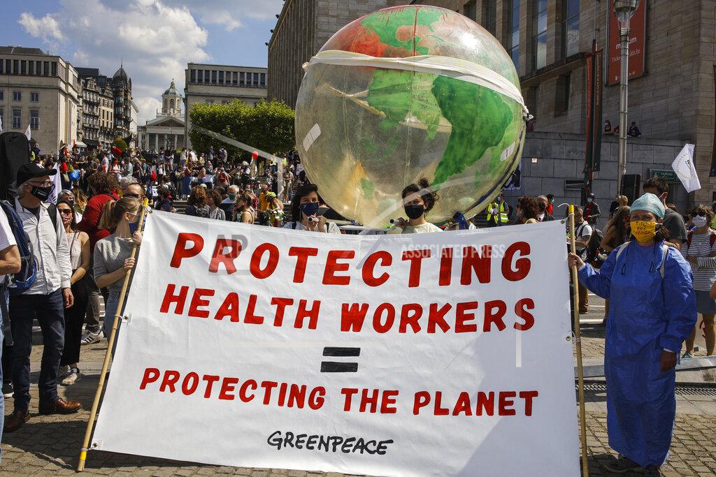 Olivier Matthys People, wearing protective face masks, gather during a healthcare workers' protest in downtown Brussels, Saturday, May 29, 2021. Protesters gathered to defend the healthcare system services and demanded more workers, better work conditions and bigger budged. (AP Photo/Olivier Matthys)