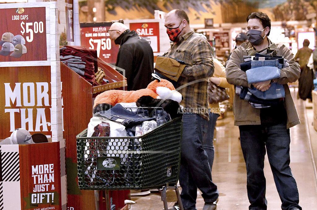 Mark Stockwell / The Sun Chronicle Shoppers get in on the Black Friday sales while shopping at Bass Pro Shops in Foxboro, Mass. Friday, Nov. 27, 2020. The outdoor specialty store opened their doors at 5 a.m. (Mark Stockwell /The Sun Chronicle via AP)
