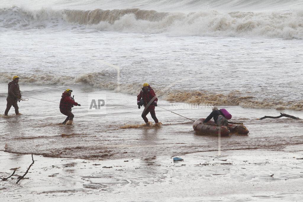 Uncredited A person is hoisted along in a dingy in muddy waters on a beach near Durban, South Africa, Sunday, May 22, 2022. More than 300 people have been evacuated from their homes as a result of renewed heavy rains, flooding and mudslides in South Africa’s KwaZulu-Natal province, weeks after severe flooding killed more than 400 people and displaced more than 40,000 others. Provincial authorities and emergency personnel say the new rains have damaged roads, homes and electricity infrastructure largely in the northern parts of the province since Friday. (AP Photo)