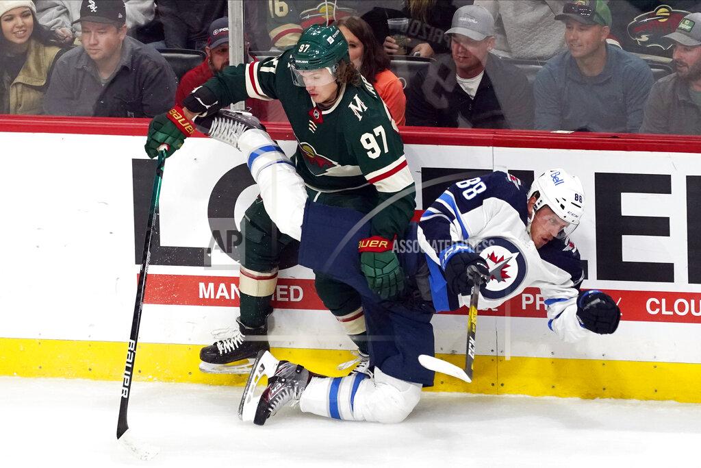 Jim Mone Minnesota Wild's Kirill Kaprizov (97) sends Winnipeg Jets' Nate Schmidt (88) to the ice during the first period of an NHL hockey game Tuesday, Oct. 19, 2021, in St. Paul, Minn. (AP Photo/Jim Mone)