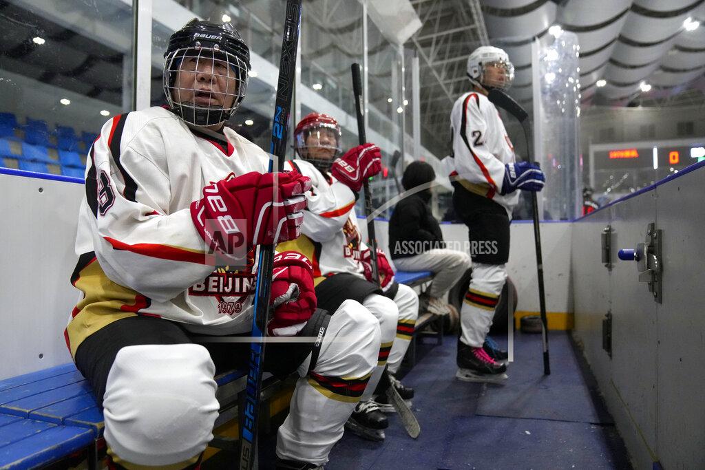Mark Schiefelbein Members of the "1979" hockey club watch the action from the bench during a hockey match at a rink in Beijing, Wednesday, Jan. 12, 2022. Spurred by enthusiasm after China was awarded the 2022 Winter Olympics, the members of a 1970s-era youth hockey team, now around 60 years old, have reunited decades later to once again take to the ice. (AP Photo/Mark Schiefelbein)