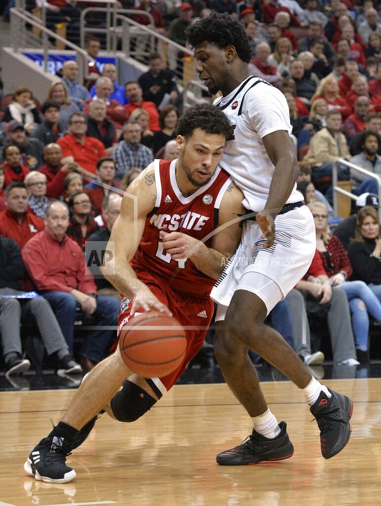 Timothy D. Easley North Carolina State guard Devon Daniels (24) drives against Louisville guard Darius Perry (2) during the first half of an NCAA college basketball game in Louisville, Ky., Thursday, Jan. 24, 2019. (AP Photo/Timothy D. Easley)