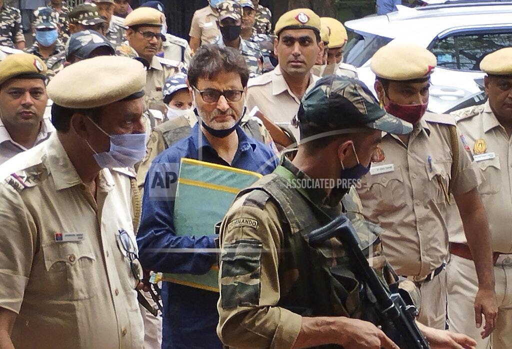 Dinesh Joshi Kashmiri separatist leader Yasin Malik is escorted by police officers to a court in New Delhi, India, Wednesday, May 25, 2022. An An Indian court on Wednesday sentenced a Kashmiri separatist leader to life in prison after finding him guilty of terrorism and sedition, triggering an anti-India protest and partial shutdown of businesses in the Indian-controlled portion of disputed Kashmir. (AP Photo/Dinesh Joshi)