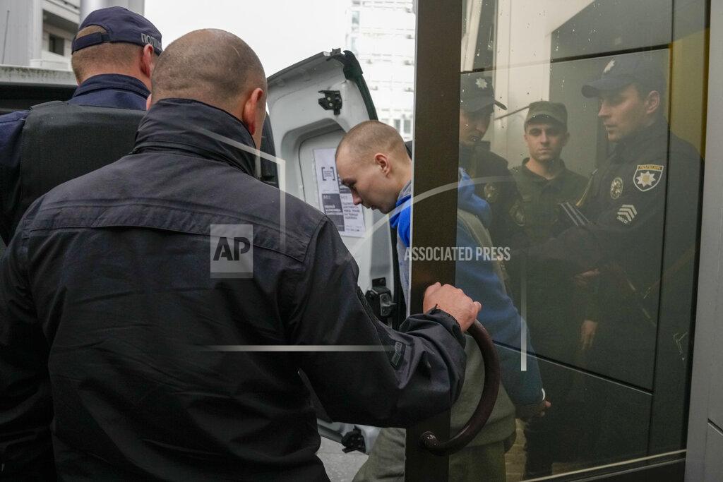 Natacha Pisarenko Police escort Russian Sgt. Vadim Shishimarin after a Ukrainian court sentenced him to life in prison in Kyiv, Ukraine, Monday, May 23, 2022. The court sentenced the 21-year-old soldier for killing a Ukrainian civilian, in the first war crimes trial held since Russia's invasion. (AP Photo/Natacha Pisarenko)