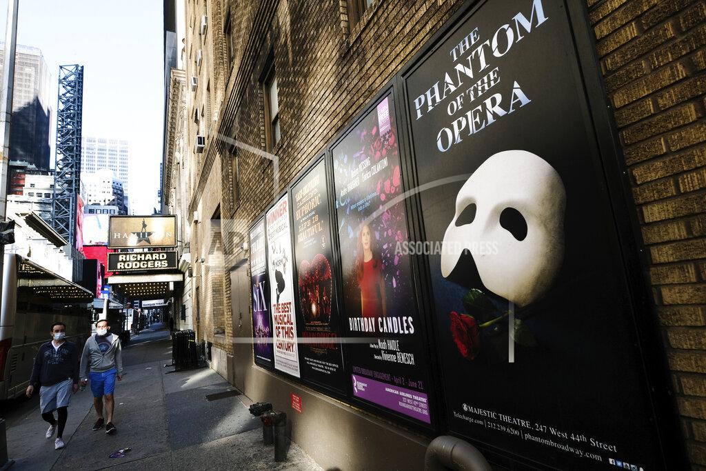 Evan Agostini FILE - Broadway posters appear outside the Richard Rodgers Theatre during Covid-19 lockdown in New York on May 13, 2020. The entertainment world has trudged on, by streaming, zooming and improvising. But its in-person soul was nearly snuffed out, and with it a lifeblood of human connection. (Photo by Evan Agostini/Invision/AP, File)