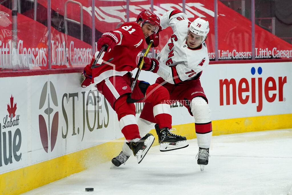Paul Sancya Carolina Hurricanes defenseman Brady Skjei (76) dumps Detroit Red Wings center Frans Nielsen (81) in the second period of an NHL hockey game Thursday, Jan. 14, 2021, in Detroit. (AP Photo/Paul Sancya)