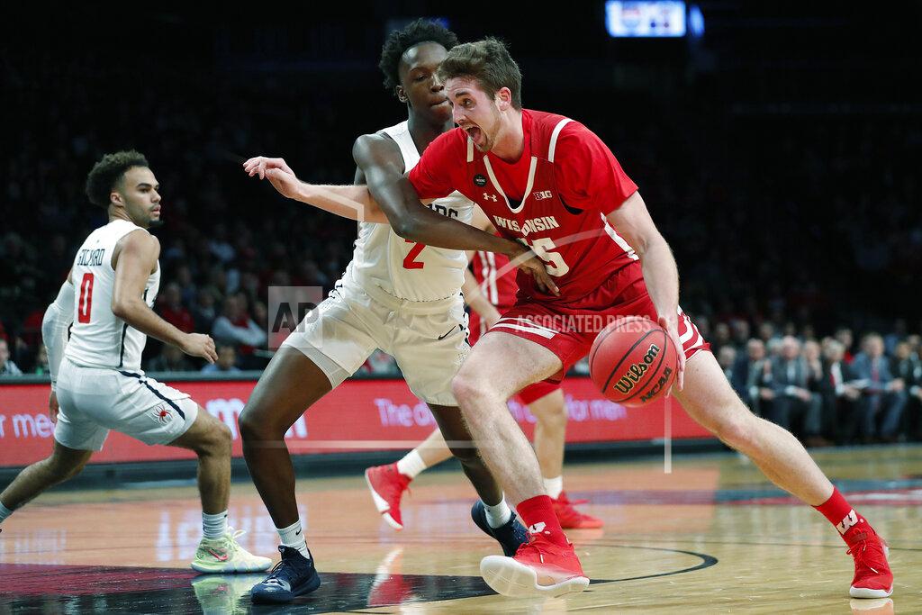 Kathy Willens Wisconsin forward Nate Reuvers (35) drives around Richmond forward Souleymane Koureissi (2) during the first half of an NCAA college basketball game in the Legends Classic, Monday, Nov. 25, 2019, in New York. (AP Photo/Kathy Willens)